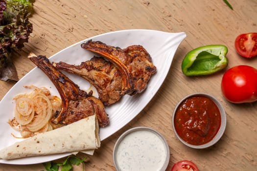 A delicious and hearty meal of grilled lamb chops, vegetables, and lavash bread. Perfect for a family dinner or a party with friends.