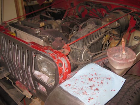 Auto Body Repair and Repainting Prep Work on Red Vehicle, Stripping Paint. High quality photo