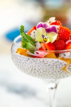 close-up dessert of chia seeds of various fruits in a glass.