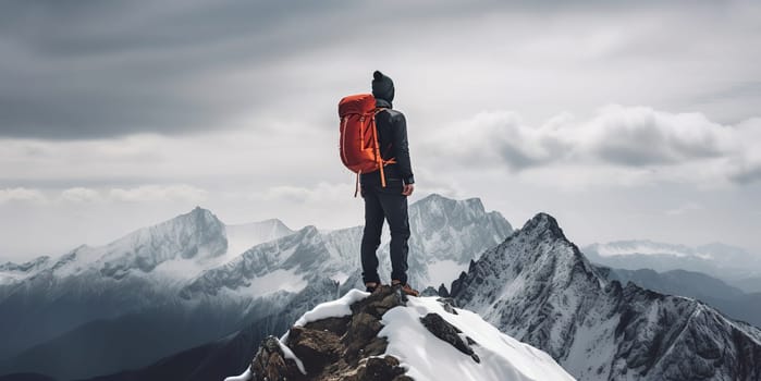 Active people in nature concept. Dressed bright orange jacket male backpacker enjoying the view as she have mountain walk. Tourist with a backpack and mountain panorama. Adventure concept