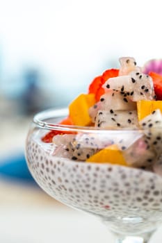 close-up dessert of chia seeds of various fruits in a glass.