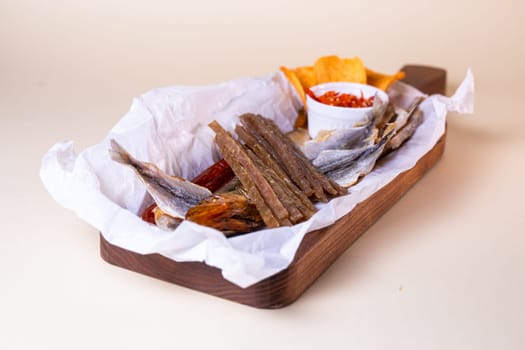 assorted dry fish for beer. fish on a wooden board.