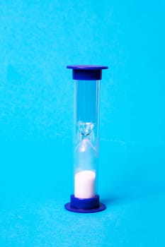 Medical hourglass on a blue background close up