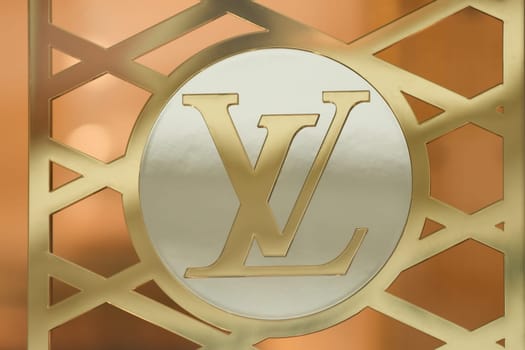 LILLE, FRANCE - FEBRUARY 21, 2024 : Golden logo sign of Louis Vuitton LV