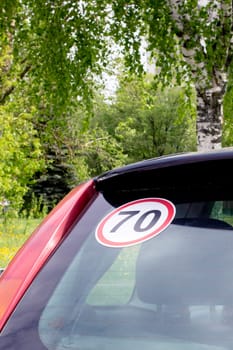 Sticker 70 on the rear window of the car close up