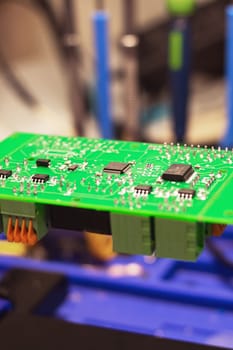 Soldering process on a green PCB close up