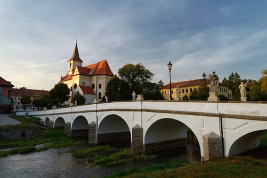 Beautiful old castle with a bridge over the river at sunset. European old architecture. Namest nad Oslavou - a city in the Czech Republic.