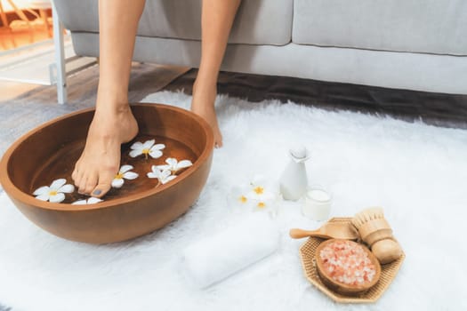 Panorama top view woman indulges in blissful foot massage at luxurious spa salon while masseur give reflexology therapy in gentle day light ambiance resort or hotel foot spa. Quiescent