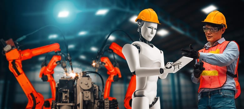 XAI Mechanized industry robot and human worker working together in future factory. Concept of artificial intelligence for industrial revolution and automation manufacturing process.