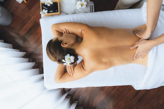 Panorama top view woman customer enjoying relaxing anti-stress spa massage and pampering with beauty skin recreation leisure in day light ambient salon spa at luxury resort or hotel. Quiescent