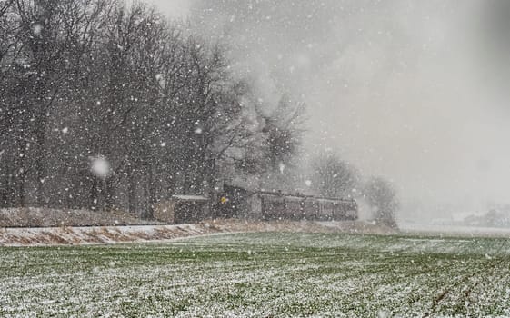 An Approaching Stem Passenger Train, in a Snow Storm, Blowing Black and White Smoke