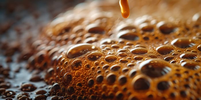 A close up, macro shot showing the bubbles and texture of a delicious, hot cup of brown coffee with a light layer of foam forming a pattern on top. Image has copy space.