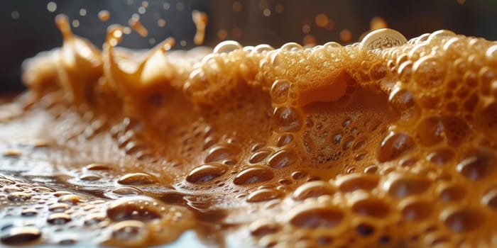 A close up, macro shot showing the bubbles and texture of a delicious, hot cup of brown coffee with a light layer of foam forming a pattern on top. Image has copy space.