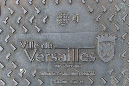 VERSAILLES, FRANCE - AUGUST 09,2023 : Decorated manhole cover at Versailles