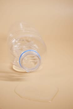 top view of a bottle of water spilled on a floor