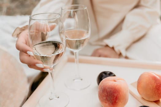 Picnic and wine tasting at sunset in the hills of Italy, Tuscany. Vineyards and open nature in the summer. Romantic dinner, fruit and wine.