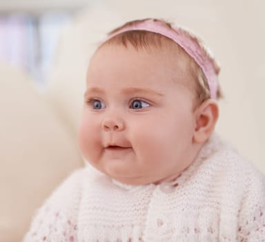 Happy, baby and face in a home with a cute, relax and sweet infant in a living room. Youth, child and house with toddler clothing in the morning ready for play on the sofa with joy and headband.