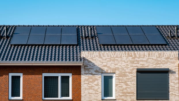 Close up of new building with black solar panels. Zonnepanelen, Zonne energie, Translation: Solar panel, Sun Energy