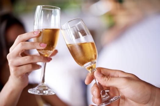 Hands, couple and glass with champagne to toast, celebrate and anniversary with date for bonding. Closeup, relationship and cheers for love with bubbles for romance on vacation, support and care