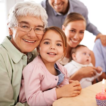 Family, grandmother or young child for birthday, cupcake and candle for celebration. Smile, home and grand daughter with grandma, senior and children at event, parents and baby in household party.