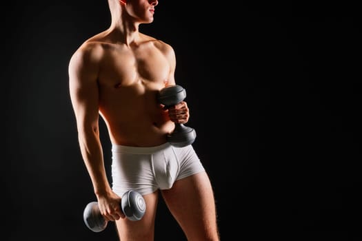 Dumbbells, fitness and man in a studio for training, exercise or bodybuilding studio shot.