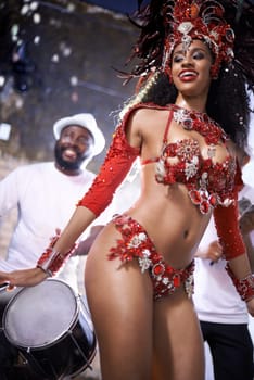 Black woman, happy and samba with band at night for carnival season celebration in Rio de janeiro with sequins costumes. Female person, dancing and fun at festival with unique fashion for culture.