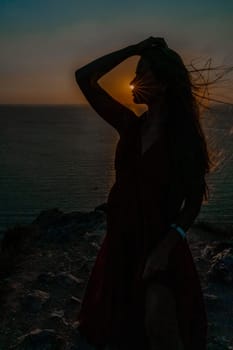 Woman sunset sea red dress, portrait happy beautiful sensual woman in a red long dress posing above the sea on sunset