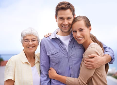 Happy, family and portrait of mother with couple, husband and wife. Embrace and smiling with love and joy for senior woman at outdoor with bonding on a peaceful day for reunion and affection.