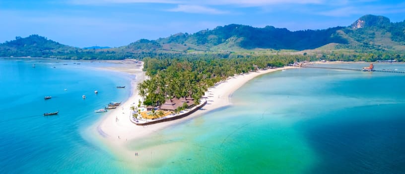 Drone top view at Koh Muk a tropical island in Trang Southern Thailand, a turqouse colored ocean in Koh Mook Trang Thailand with a white soft powdery sand beach