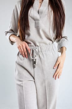 Model in elegant linen pantsuit, perfect for casual or smart-casual office looks. Breathable, lightweight fabric ideal for warm weather. Available in various colors to match your style.