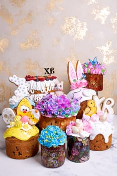 A variety of Easter cakes with intricate icing decorations, featuring bunnies, chicks, flowers, and butterflies. Perfect for a festive Easter celebration. Isolated on a beige background.