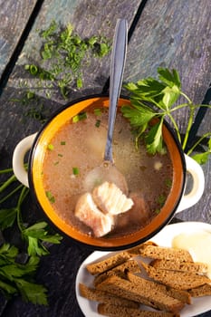 A delightful bowl of fish soup with a rich broth, fresh vegetables, and aromatic herbs, accompanied by a side of crusty bread. Ideal for a wholesome and satisfying meal, perfect for any occasion.