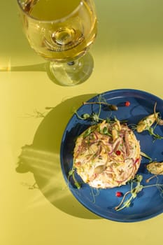 Seafood salad with succulent shrimp, crab, avocado, and light mayo on a blue plate. Served with white wine on a yellow background. Perfect for a light and satisfying meal.