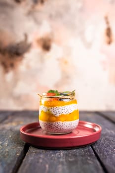 Chia seed pudding with mango, mixed berries, milk, Greek yogurt, assorted fruit, and honey. Tropical-inspired delight for a refreshing summer treat.