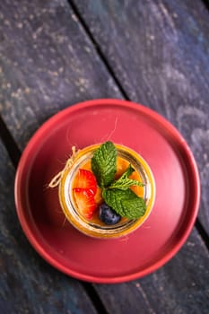 Chia seed pudding with mango, mixed berries, milk, Greek yogurt, assorted fruit, and honey. Tropical-inspired delight for a refreshing summer treat.