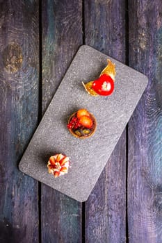 An exquisite display of four decadent slices of cake elegantly arranged on a sleek marble board, evoking a sense of culinary opulence.