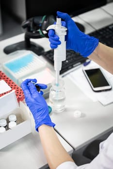 Lab technician works with close-up analyses at the table.