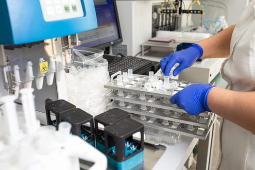 Lab technician works with gloves in hospital.