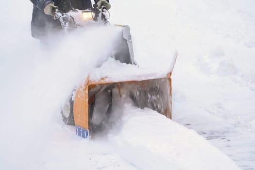 KAMCHATKA, RUSSIA - DEC 28, 2023: After a winter cyclone, a snow blower machine is used to remove snow from the road. The machine throws the snow, clearing the area after the snowstorm has passed.