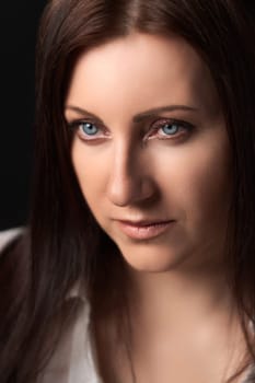 Portrait of Caucasian ethnicity adult woman forty years old. Beautiful female human face of brunette with gray eyes. Soft selective focus, deep-of-field of eyes.