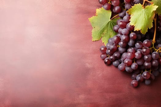 Bunch of fresh grapes with leaves on a textured background.