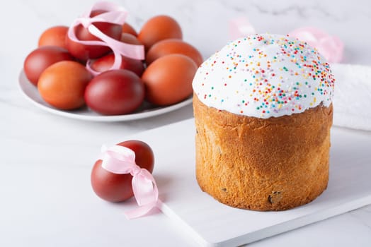 Delicious Easter cakes and eggs on light background.