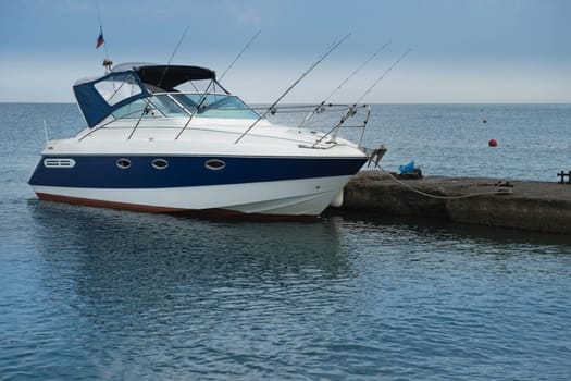 The boat is at the pier in the resort village of Nebug, Krasnodar Territory.