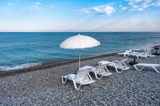 Idyllic morning on the beach: sun loungers and sun umbrellas in the resort village of Nebug, Krasnodar Territory, Russia