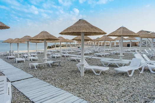 Beach umbrellas from straw in the resort village of Nebug, Krasnodar Territory, Russia.