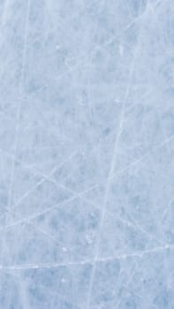 Ice background with marks from skating and hockey. blue texture