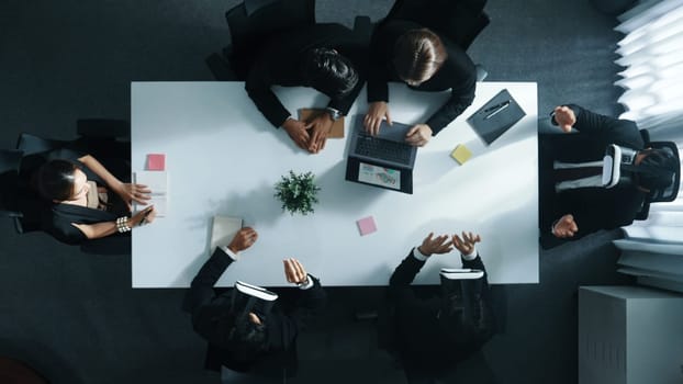 Top view of smart manager give vr head set to businesspeople while businesswoman prepare data analysis or analytic graph in laptop at meeting. Startup team preparing to enter meta verse. Directorate.