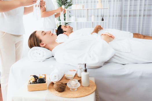Serene modern daylight ambiance of spa salon, couple customer indulges in rejuvenating with facial skincare mask. Facial skin treatment and beauty cosmetology procedure for face. Quiescent