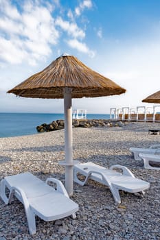 Beach umbrellas from straw in the resort village of Nebug, Krasnodar Territory, Russia.