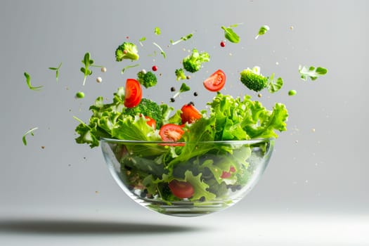 The photo shows a glass bowl filled with fresh lettuce and juicy tomatoes, ready to be used as ingredients for a delicious meal.